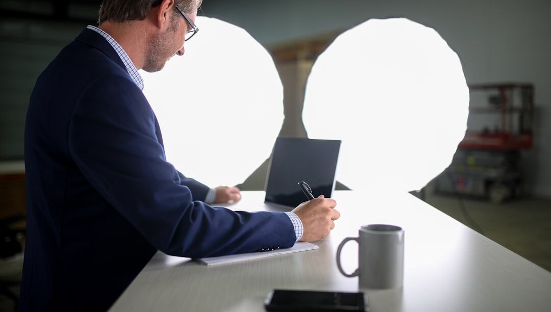 Journalist writing an article on a laptop at a desk