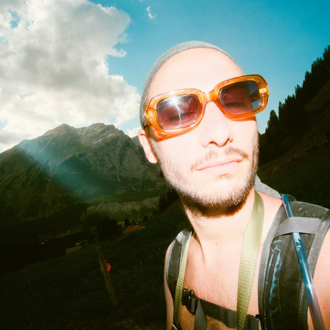 Portrait of a young Swiss photojournalist with a camera